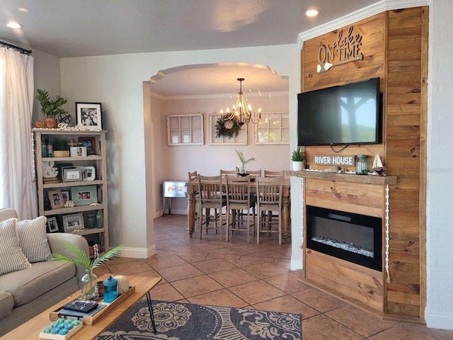 tiled living area featuring arched walkways, baseboards, an inviting chandelier, and recessed lighting