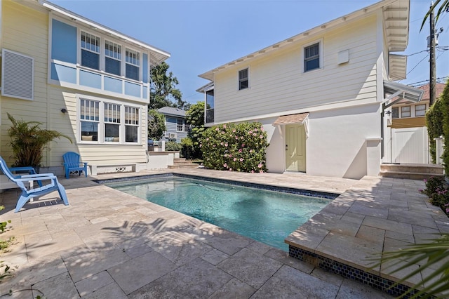 outdoor pool with a patio area