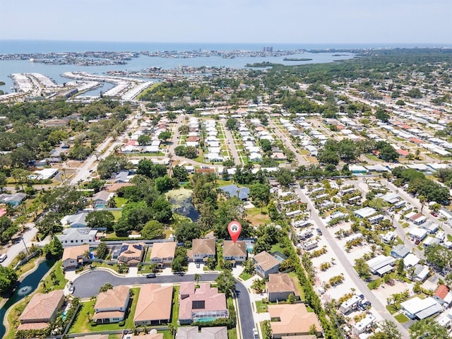 drone / aerial view featuring a residential view and a water view