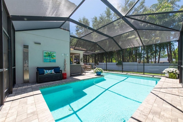 view of swimming pool featuring a patio, a fenced in pool, and a lanai