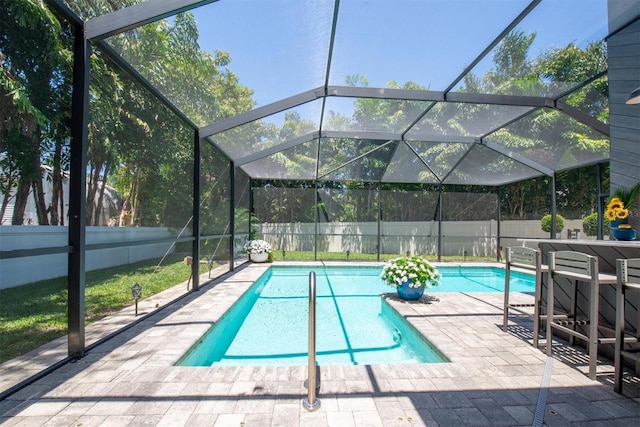 view of swimming pool featuring a lanai, a fenced backyard, a fenced in pool, and a patio area