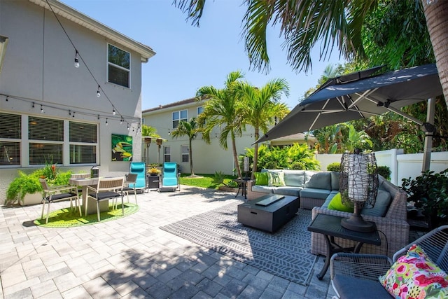 view of patio featuring an outdoor living space, outdoor dining area, and fence
