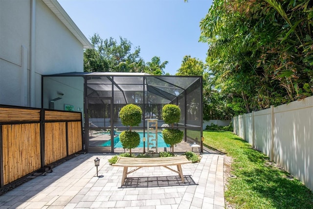 view of patio with a fenced in pool, a lanai, and a fenced backyard