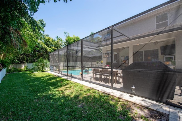 view of swimming pool with a patio, a fenced in pool, glass enclosure, a lawn, and a fenced backyard