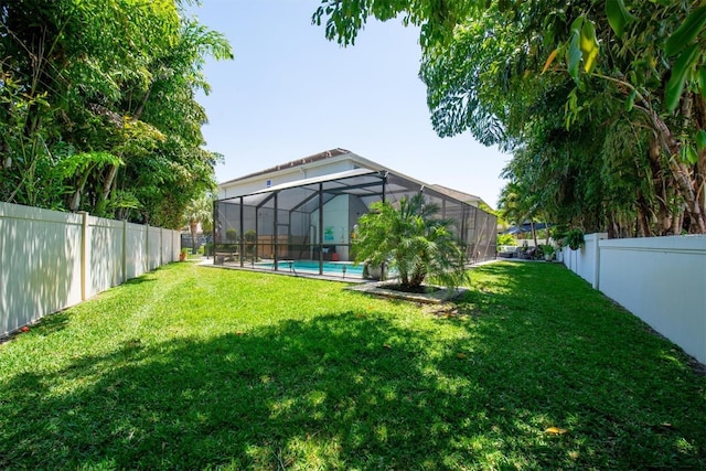 view of yard featuring a lanai, a fenced backyard, and a fenced in pool