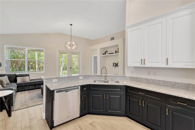 kitchen featuring a sink, lofted ceiling, white cabinetry, dishwasher, and dark cabinets