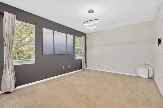 empty room featuring baseboards and carpet floors