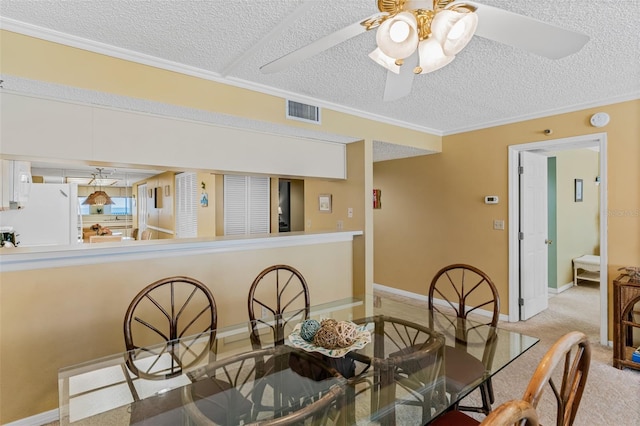 18400 Gulf Blvd Unit 1109, Indian Shores, FL 33785 - dining room with a textured ceiling, a ceiling fan, ornamental molding, baseboards, and carpet floors