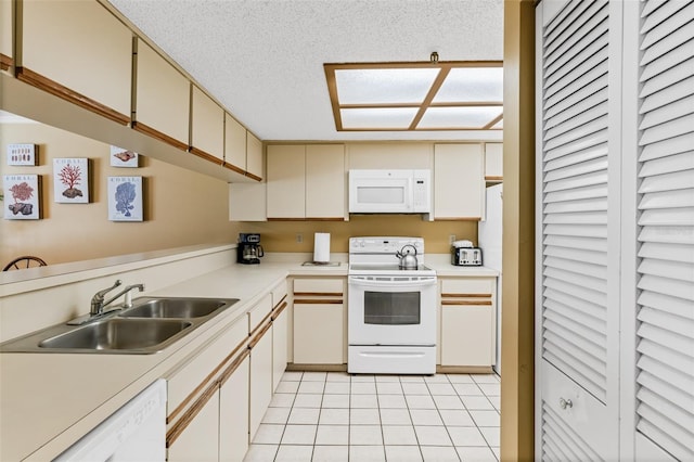 18400 Gulf Blvd Unit 1109, Indian Shores, FL 33785 - kitchen featuring white appliances, a sink, light countertops, light tile patterned floors, and a textured ceiling