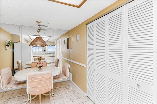 18400 Gulf Blvd Unit 1109, Indian Shores, FL 33785 - dining area with light tile patterned floors and baseboards