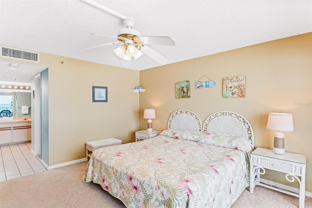 18400 Gulf Blvd Unit 1109, Indian Shores, FL 33785 - carpeted bedroom with baseboards, a ceiling fan, tile patterned floors, a textured ceiling, and ensuite bathroom