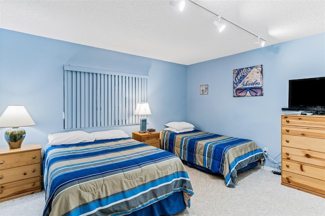18400 Gulf Blvd Unit 1109, Indian Shores, FL 33785 - bedroom with carpet, rail lighting, and a textured ceiling