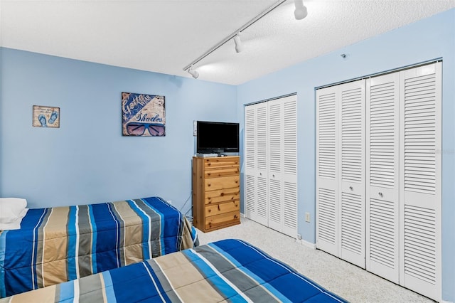 18400 Gulf Blvd Unit 1109, Indian Shores, FL 33785 - carpeted bedroom featuring multiple closets, track lighting, and ceiling fan