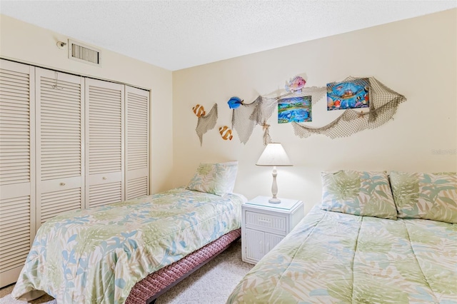 18400 Gulf Blvd Unit 1109, Indian Shores, FL 33785 - carpeted bedroom featuring a closet and a textured ceiling