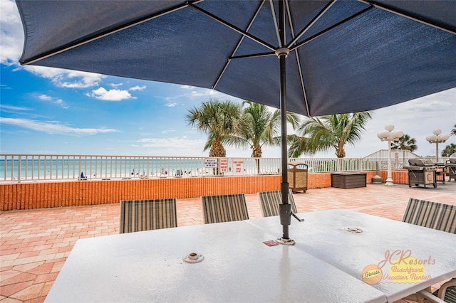 18400 Gulf Blvd Unit 1109, Indian Shores, FL 33785 - view of patio / terrace with outdoor dining space, grilling area, and a water view