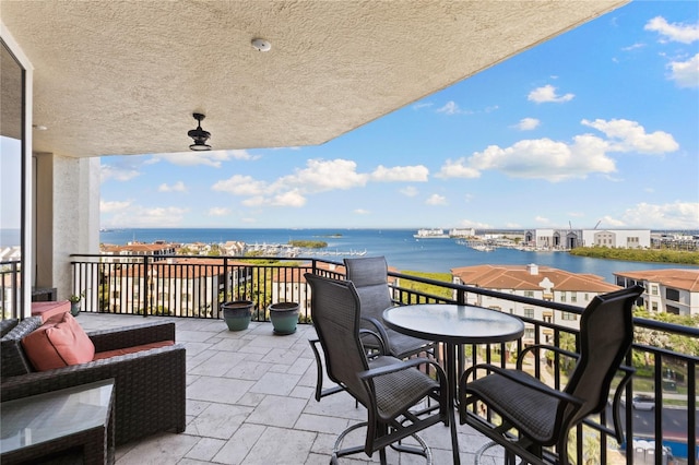 exterior space featuring a balcony and a water view