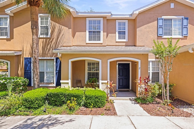 view of front of house featuring stucco siding and covered porch