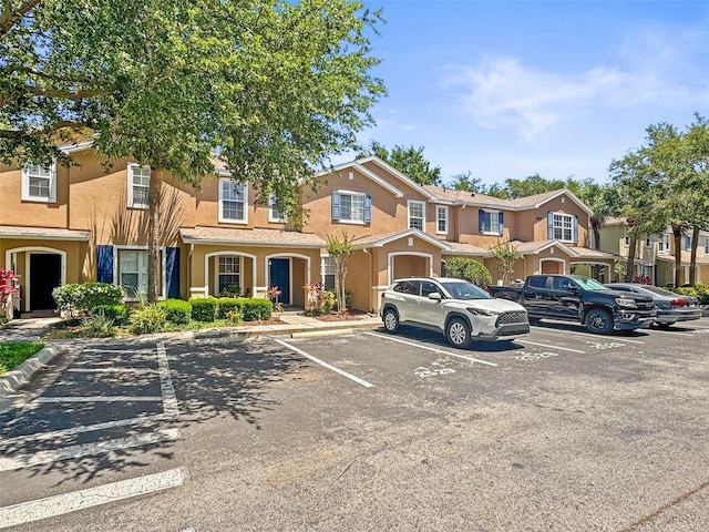 uncovered parking lot featuring a residential view