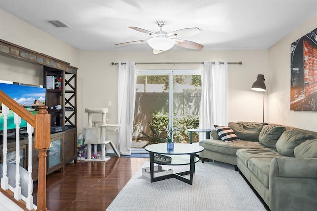 living room featuring ceiling fan, visible vents, and wood finished floors