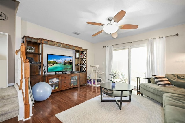 living room featuring ceiling fan, visible vents, and wood finished floors