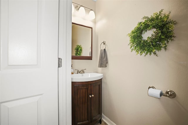 bathroom with vanity and baseboards