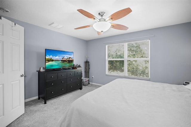 carpeted bedroom with baseboards and ceiling fan
