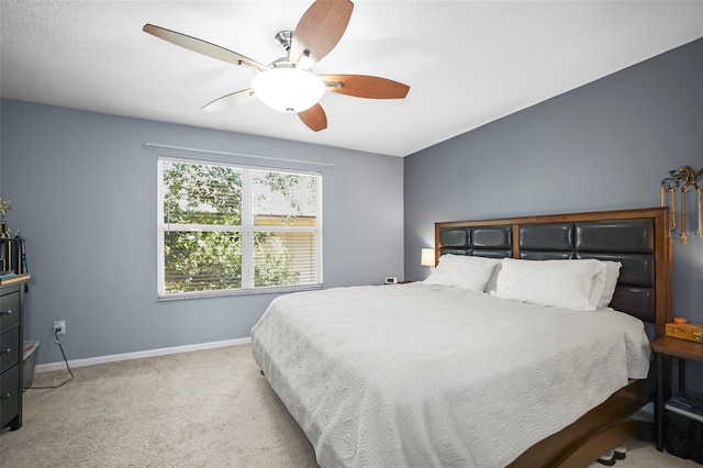 bedroom featuring a ceiling fan, baseboards, and carpet