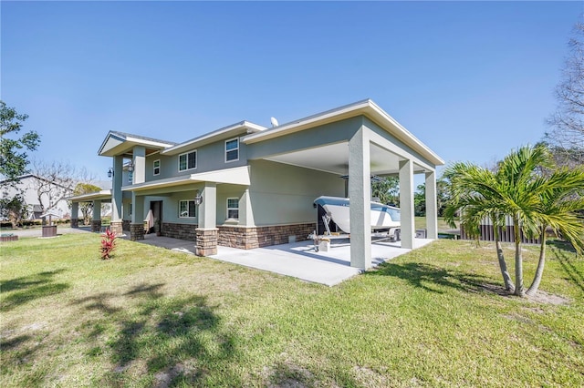 592 Ken Hubbard Rd, Terra Ceia, FL 34250 - back of property with a patio area, a carport, and a yard