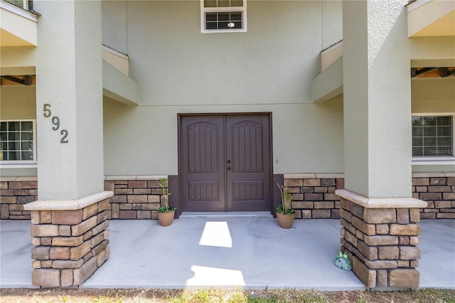 592 Ken Hubbard Rd, Terra Ceia, FL 34250 - doorway to property with stone siding and stucco siding