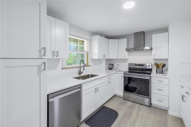592 Ken Hubbard Rd, Terra Ceia, FL 34250 - kitchen with wall chimney exhaust hood, stainless steel appliances, a sink, light countertops, and light wood-style floors