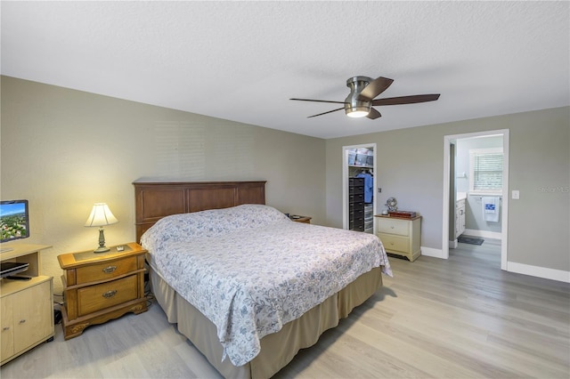 592 Ken Hubbard Rd, Terra Ceia, FL 34250 - bedroom with light wood-style floors, baseboards, ceiling fan, a textured ceiling, and a closet
