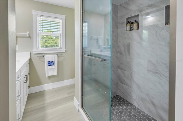 592 Ken Hubbard Rd, Terra Ceia, FL 34250 - full bathroom with vanity, a marble finish shower, wood finished floors, and baseboards