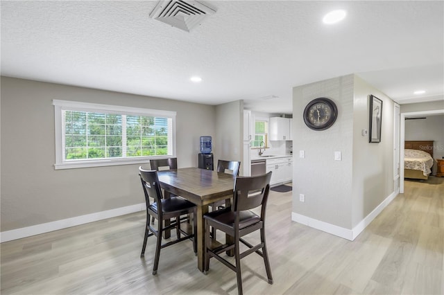 592 Ken Hubbard Rd, Terra Ceia, FL 34250 - dining space with baseboards, healthy amount of natural light, light wood-type flooring, recessed lighting, and a textured ceiling