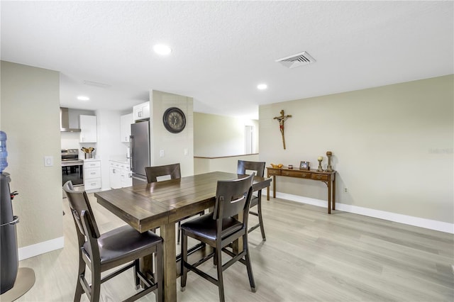 592 Ken Hubbard Rd, Terra Ceia, FL 34250 - dining room featuring baseboards, light wood-type flooring, recessed lighting, and a textured ceiling