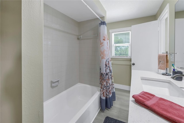 592 Ken Hubbard Rd, Terra Ceia, FL 34250 - bathroom featuring wood finished floors, shower / bathtub combination with curtain, vanity, and baseboards