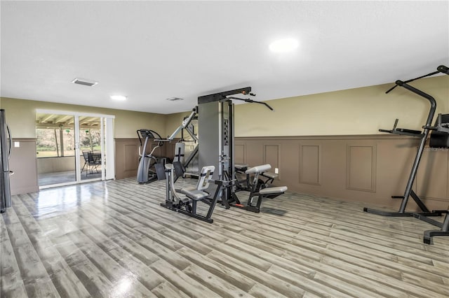 592 Ken Hubbard Rd, Terra Ceia, FL 34250 - exercise room featuring a decorative wall, a wainscoted wall, light wood-type flooring, and recessed lighting