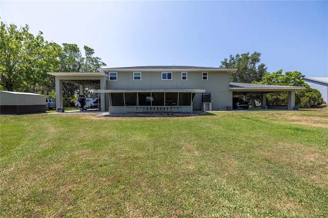 592 Ken Hubbard Rd, Terra Ceia, FL 34250 - back of house featuring an attached carport and a yard