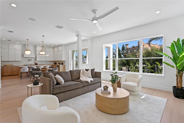 living room with recessed lighting, visible vents, ceiling fan, and light wood-style floors