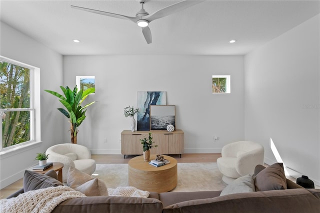 living room featuring light wood-type flooring and baseboards