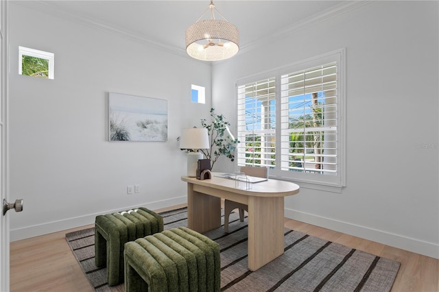office area featuring ornamental molding, an inviting chandelier, light wood-style flooring, and baseboards