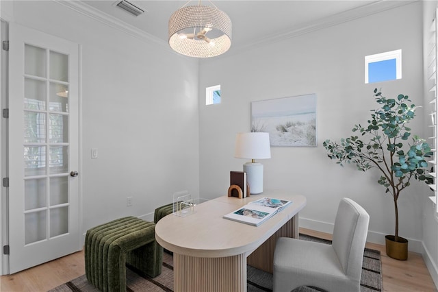 office area with a chandelier, light wood-style floors, visible vents, baseboards, and ornamental molding