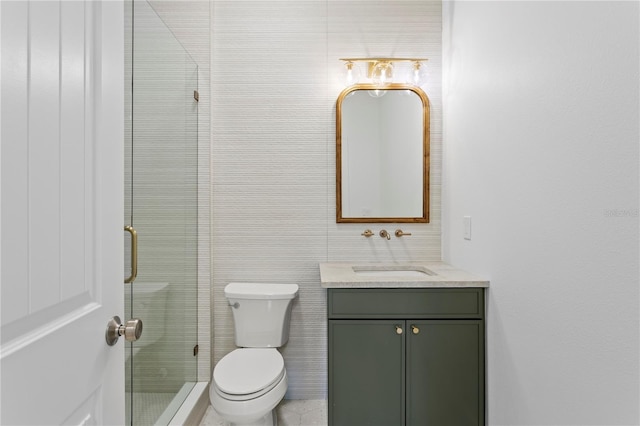 full bathroom with toilet, vanity, and a shower stall