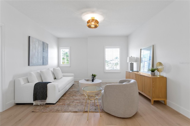 living room featuring light wood finished floors and baseboards