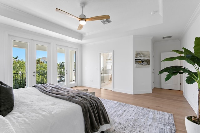 bedroom featuring crown molding, visible vents, access to outside, and a tray ceiling