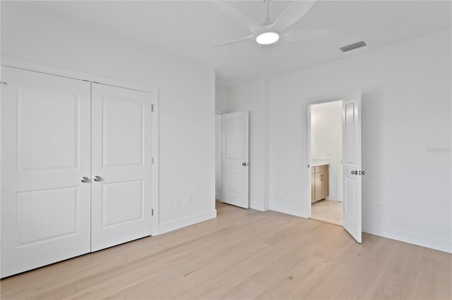 unfurnished bedroom with baseboards, visible vents, and light wood-type flooring