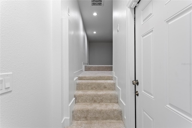 stairs with recessed lighting, visible vents, carpet, and baseboards