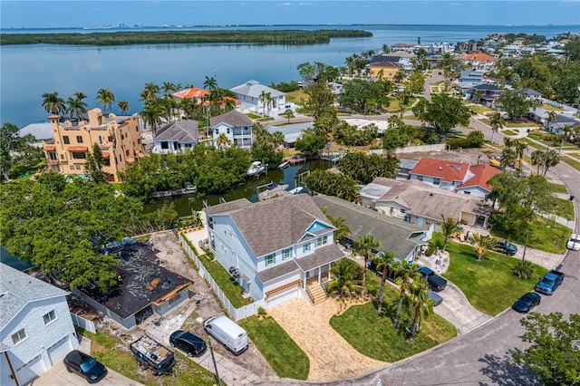 drone / aerial view with a residential view and a water view