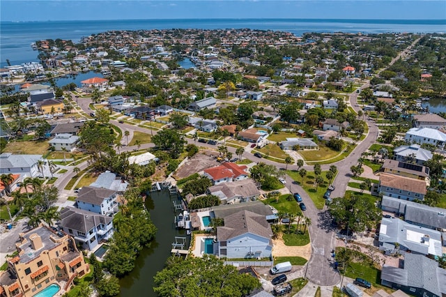 drone / aerial view with a water view and a residential view