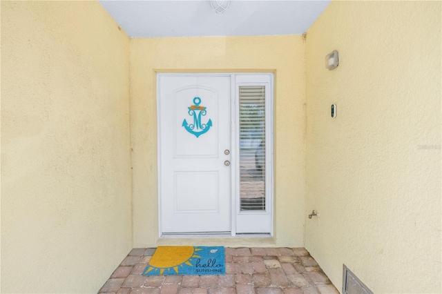 100 Windrush Blvd Unit 1, Indian Rocks Beach, FL 33785 - doorway to property featuring stucco siding