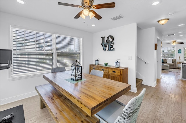 100 Windrush Blvd Unit 1, Indian Rocks Beach, FL 33785 - dining area featuring ceiling fan, baseboards, recessed lighting, light wood-style flooring, and stairs